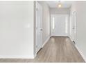 Bright foyer with wood-look flooring and a white front door with sidelights, creating an inviting entry at 351 Lakota Loop, Longs, SC 29568