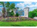 Sign for Carolina Yacht Landing with colorful flowers, trees, and brick pillars at 4519 N Plantation Harbour Dr. # X - 19, Little River, SC 29566