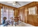 Cozy breakfast nook features wood paneling, round table, and natural light from the window at 4810 Circle Dr., Loris, SC 29569