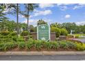 Windsor Green at Waterford Plantation entrance sign surrounded by beautiful landscaping and lush greenery at 4936 Crab Pond Ct. # 201, Myrtle Beach, SC 29579