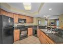 Well-equipped kitchen with stainless steel appliances, granite countertops, and wooden cabinets at 504 N Ocean Blvd. # 310, Myrtle Beach, SC 29577