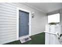 Inviting condo front door with sidelight, classic hardware, and a welcome mat at 5750 Oyster Catcher Dr. # 1034, North Myrtle Beach, SC 29582
