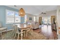 Bright living and dining space with wood floors, a decorative rug, and sliding glass doors to a private deck at 601 Hillside Dr. N # 3031, North Myrtle Beach, SC 29582