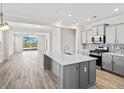 Well-designed kitchen with island, stainless steel appliances, and an open view to living area at 619 Castle Ct., Myrtle Beach, SC 29579