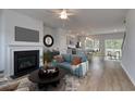 Elegant living room with a fireplace, modern decor, and an open floor plan at 667 Mccorkle Place, Conway, SC 29526