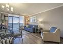 Inviting living room with balcony access showcasing ocean views, comfortable seating, and stylish decor at 6900 N Ocean Blvd. # 1235, Myrtle Beach, SC 29572