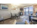 Relaxing living room area featuring a dining table and chairs, a sofa, and access to a private balcony at 6900 N Ocean Blvd. # 1235, Myrtle Beach, SC 29572