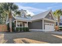 Inviting single-story home with a metal roof, covered front porch, and two car garage at 799 Mount Gilead Place Dr., Murrells Inlet, SC 29576