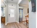 Welcoming foyer with wood flooring and decorative door, offering an inviting entrance to the home at 808 Kingfisher Dr., Myrtle Beach, SC 29577