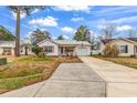 Street view of a single story home boasting tidy landscaping, an American flag, and a metal roof at 9514 Leeds Circle, Myrtle Beach, SC 29588