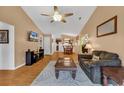 A spacious living room offering a ceiling fan, and open view to the kitchen, and hardwood flooring at 9514 Leeds Circle, Myrtle Beach, SC 29588