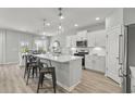 Modern, open kitchen with a large island, stainless steel appliances, and bright white cabinetry at 1275 Winding Creek Way, Myrtle Beach, SC 29588