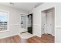 Bright foyer featuring hardwood floors, white trim, and a view of the front door and adjacent rooms at 1412 Gailard Dr., Conway, SC 29526