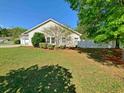 Lush, green backyard with a white fence, offering privacy and plenty of space for outdoor activities at 152 Rose Water Loop, Myrtle Beach, SC 29588