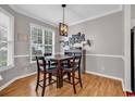 Cozy dining room featuring hardwood floors, a modern light fixture, and a large window at 1547 Harlow Ct., Myrtle Beach, SC 29579