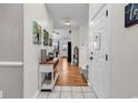 Inviting foyer with tiled flooring, hardwood hallway, and neutral paint colors at 1547 Harlow Ct., Myrtle Beach, SC 29579
