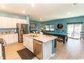 Open-concept kitchen with stainless steel appliances, granite countertops, and an island with a sink at 184 Carolina Lakes Blvd., Myrtle Beach, SC 29588