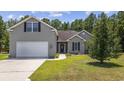 Well-maintained home with a two-car garage, classic siding, and attractive landscaping at 197 Black Bear Rd., Myrtle Beach, SC 29588