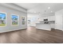 Bright and airy living room with wood floors and an open layout, connecting seamlessly to the kitchen at 2424 Campton Loop, Conway, SC 29527