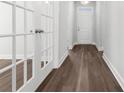 Entryway with hardwood floors and glass panel doors on either side, leading to other rooms at 2443 Campton Loop, Conway, SC 29527