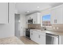 Bright kitchen featuring white cabinets, stainless steel appliances, granite countertops, and tile backsplash at 2483 Morlynn Dr., Myrtle Beach, SC 29577