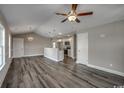 Bright living space with vaulted ceiling, modern light fixtures, and an open view into the kitchen area at 2582 Cottonwood Dr., Loris, SC 29569