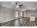 Open-concept living room with vaulted ceiling, ceiling fan, recessed lighting, and luxury vinyl plank flooring at 2582 Cottonwood Dr., Loris, SC 29569