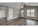 Inviting living area featuring luxury vinyl plank floors, natural light, vaulted ceilings, and neutral paint at 2582 Cottonwood Dr., Loris, SC 29569