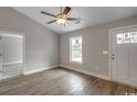 Bright living room with vaulted ceiling, ceiling fan, and wood-look flooring complements natural light at 2588 Cottonwood Dr., Loris, SC 29569