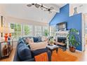 Bright living room with a cozy fireplace, modern ceiling fans, and large windows at 314 Lyons Cove Dr., Myrtle Beach, SC 29577