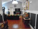 View of a large living room boasting hardwood floors, neutral walls, and stylish furnishings at 3158 River Bluff Ln., Little River, SC 29566