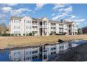 The apartment building is reflected in the stream, showcasing beautiful architecture at 3762 Citation Way # 1013, Myrtle Beach, SC 29577