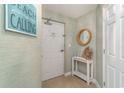Hallway with a table and a wood mirror and sign that says The Beach is Calling at 4103 N Ocean Blvd. # 207, North Myrtle Beach, SC 29582