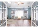 Cozy living area with large windows, modern furnishings, and light blue walls at 481 Morning Glory Ct., Myrtle Beach, SC 29579