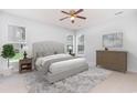 Serene bedroom with neutral tones, plush carpeting, and large windows offering ample natural light at 481 Morning Glory Ct., Myrtle Beach, SC 29579