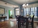 Dining room showcasing hardwood floors, a modern chandelier, and open layout at 5318 Tremiti Ln., Myrtle Beach, SC 29579