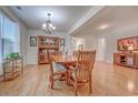 Spacious dining area featuring hardwood floors, a wooden dining set, and decorative hutch with natural light at 676 Lafayette Park Dr., Little River, SC 29566