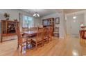 Elegant dining room with a large wooden table, chandelier, and natural light streaming through the window at 676 Lafayette Park Dr., Little River, SC 29566
