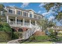 Beautiful home with a inviting front porch, manicured yard, and detailed brickwork at 80 Stonington Dr., Murrells Inlet, SC 29576