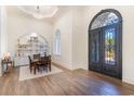 Elegant dining area featuring wood floors, a built-in shelving area, and an ornate entry door at 8285 Leone Circle, Myrtle Beach, SC 29579