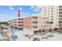 Coastal condo building featuring multi-level balconies and beach access at 900 N Waccamaw Dr. # 303, Murrells Inlet, SC 29576