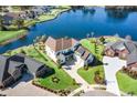 Aerial view of a beautiful light blue home with a large backyard overlooking a serene lake at 1042 Muscovy Pl., Conway, SC 29526