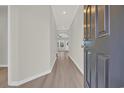 Inviting hallway with wood-look floors leads to bright living spaces at 1064 Jase Dr., Longs, SC 29568