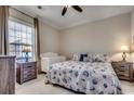 Cozy bedroom featuring a queen-sized bed with seashell patterned bedding and a white crib near a window at 123 Avian Dr. # 102, Pawleys Island, SC 29585