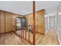 Inviting entryway with wood paneling, railing, bench and hardwood floors at 125 Ole Cedar Ln., Conway, SC 29526