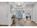 Bright foyer with wood floors, stylish decor, and a view into the open living spaces at 3228 Goldenrain Ln., Little River, SC 29566