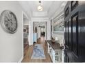 Bright foyer with wood floors, stylish decor, and a view into the open living spaces at 3228 Goldenrain Ln., Little River, SC 29566