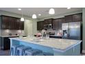 Bright kitchen showcasing a large island, granite countertops, pendant lights, and stainless steel appliances at 354 Glacier Way, Conway, SC 29526