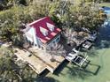 Aerial view of a waterfront home with a red roof, private docks, and scenic surroundings at 3615 Sunfish St., Murrells Inlet, SC 29576