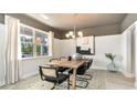 Bright dining area with modern chandelier, large windows, and an elegant wooden table at 362 Glacier Way, Conway, SC 29526